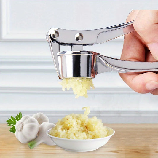 Stainless steel garlic press crushing garlic cloves with minced garlic on a plate, showcasing a heavy-duty kitchen tool.