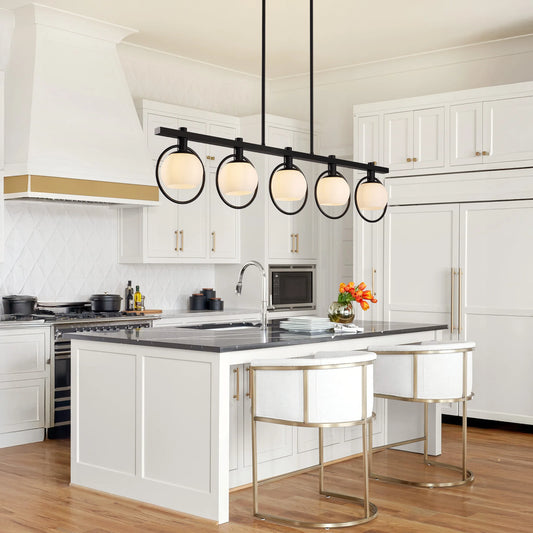 Modern chandelier pendant light in a stylish kitchen with five adjustable glass shades in a black frame.