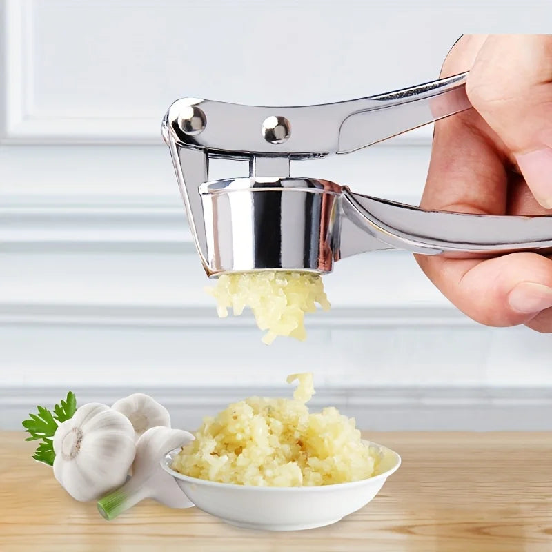 Stainless steel garlic press crushing fresh minced garlic in a bowl, showcasing a heavy-duty kitchen tool for easy food preparation.